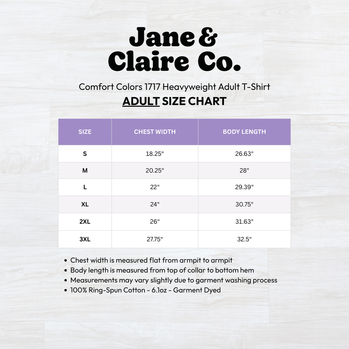 An adult size chart graphic for Jane & Claire Co. Comfort Colors 1717 Heavyweight Adult T-Shirt, showing a size table from S to 3XL with chest width and body length measurements, plus a brief note about measurement instructions on a light wood background.